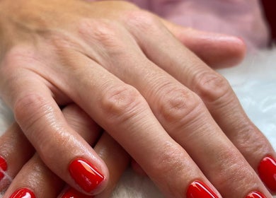 Close-up of red manicured nails at Little Red, London, England, GB.