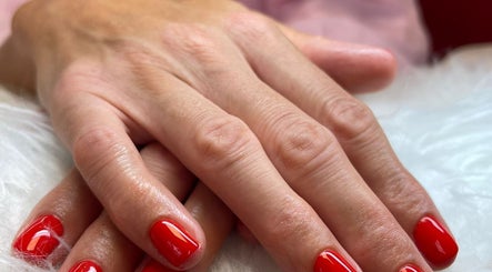 Close-up of red manicured nails at Little Red, London, England, GB.
