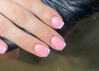 Elegant French manicure at C.B.Nails, Bacup, England, GB. Perfectly polished pink nails with white tips.