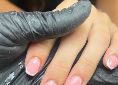 Close-up of manicured nails at C.B.Nails, Bacup, England, GB, showcasing a French polish style.