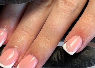 Freshly manicured French tips at C.B.Nails in Bacup, England, GB showcasing flawless pink and white design.