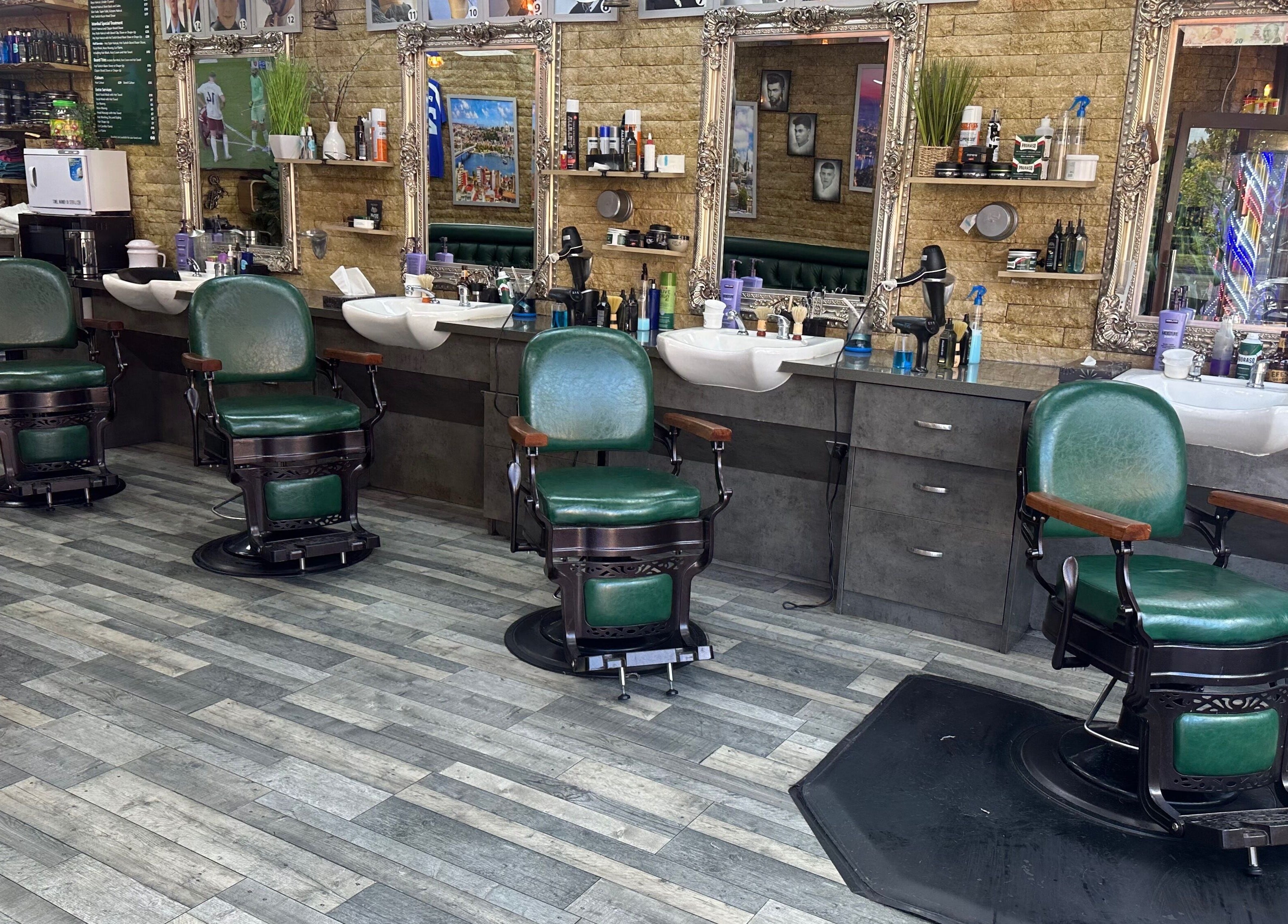 Interior of Istanbul Barber Rosehill, Sutton, England, featuring vintage green barber chairs and mirrored stations.