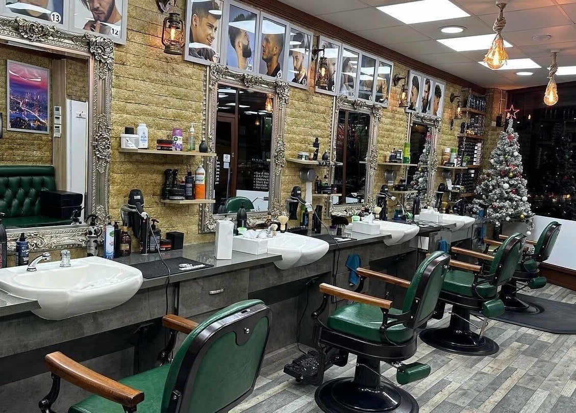 Interior of Istanbul Barber Rosehill in Sutton, England, GB with vintage decor and mirrored stations.