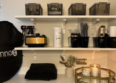 Shelves stocked with tanning supplies at Tanning By Hazel, West Parley, England, GB.