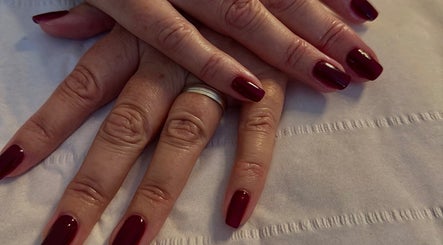 Deep red manicure at The Lush Lounge, Midhurst, England, GB, showcasing elegance and style on well-groomed nails.