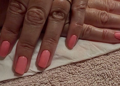 Elegant peach manicure at The Lush Lounge, Midhurst, England, GB showcasing impeccable nail care.