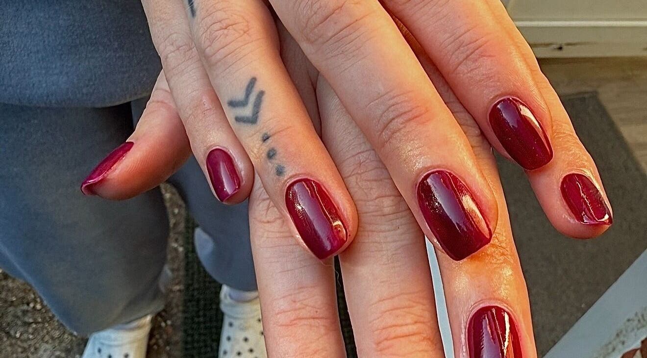 Elegant red manicured nails at The Lush Lounge, Midhurst, England, GB offering premium nail services.