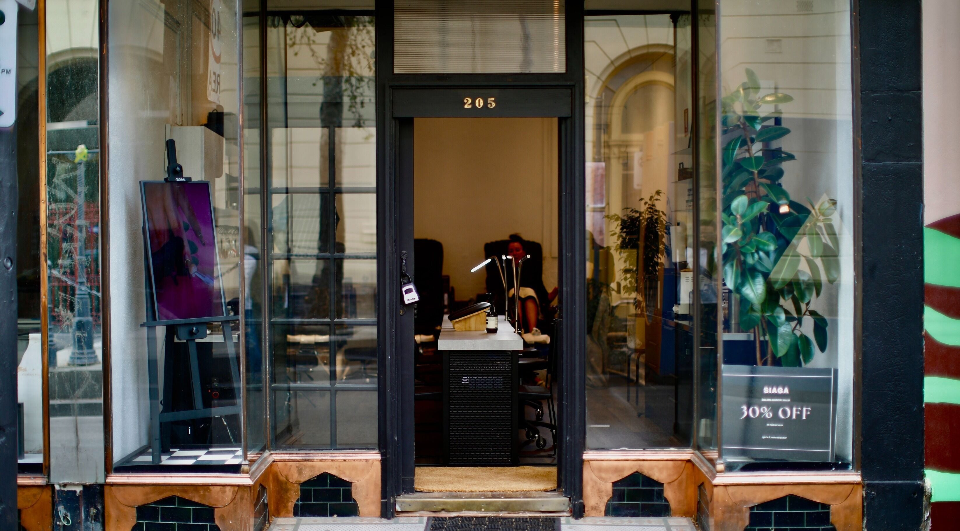 Stylish entrance of Siaga Melbourne in Prahran, Victoria, AU with modern decor and sale sign.