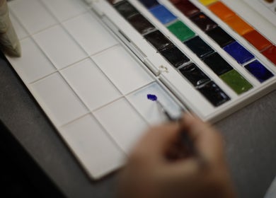 Close-up of a color palette at Siaga Melbourne, Prahran, Victoria, AU. An artist mixes vibrant paints.