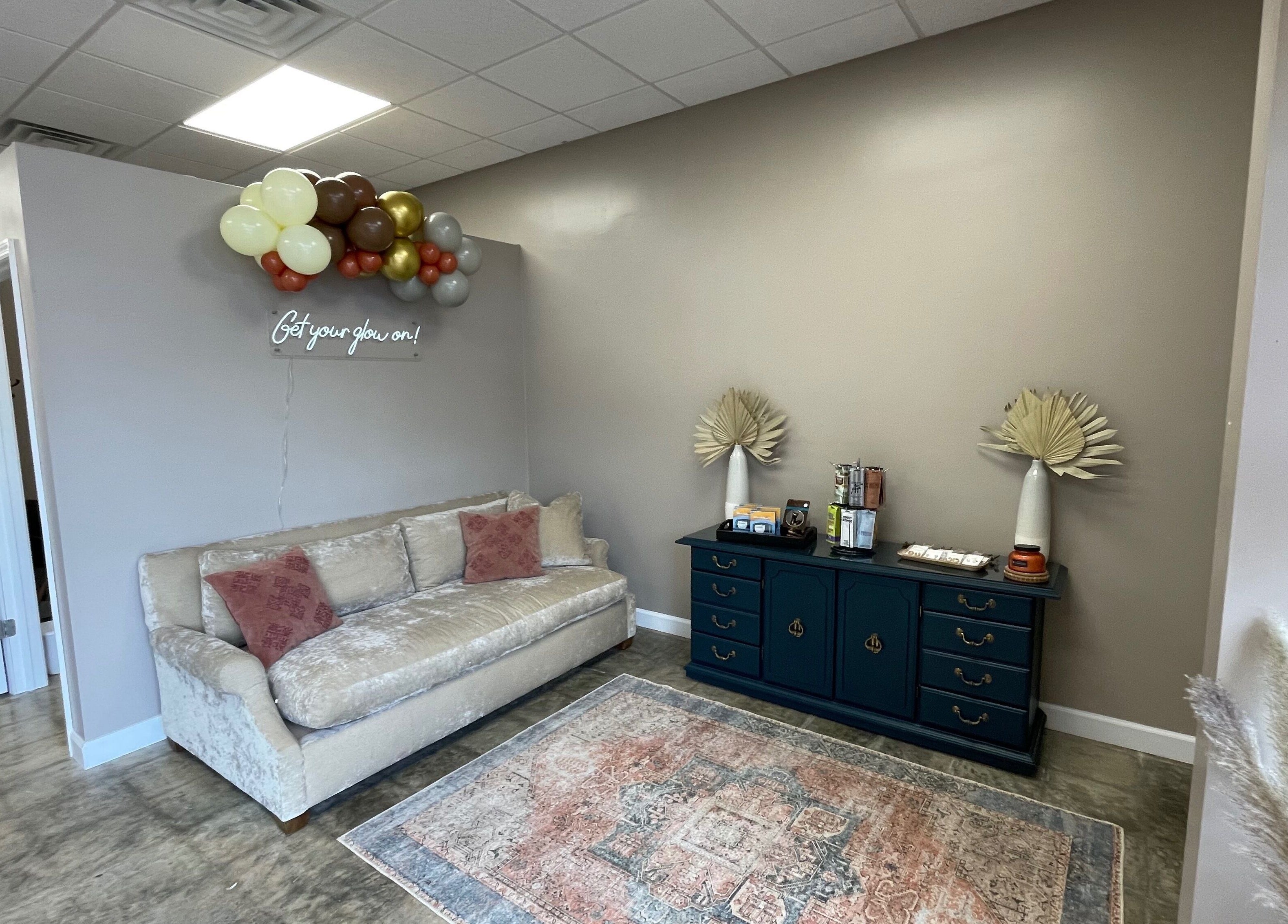 Inviting lounge at Ready Set Glow Tanning LLC, La Fayette, Alabama, US, with cozy sofa and elegant decor.