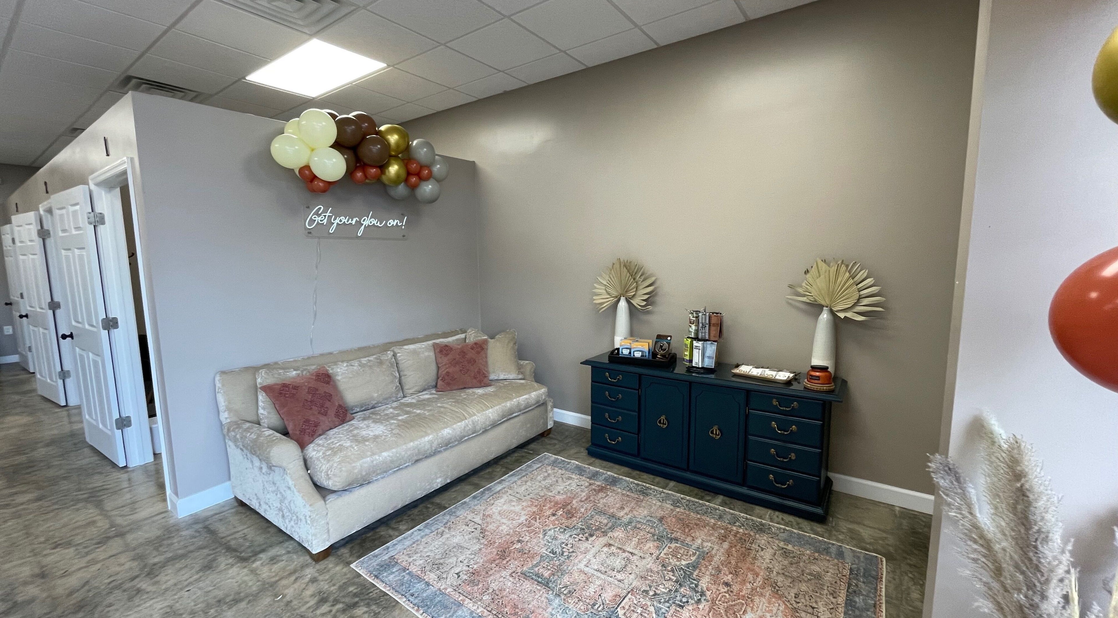 Inviting lounge at Ready Set Glow Tanning LLC, La Fayette, Alabama, US, with cozy sofa and elegant decor.