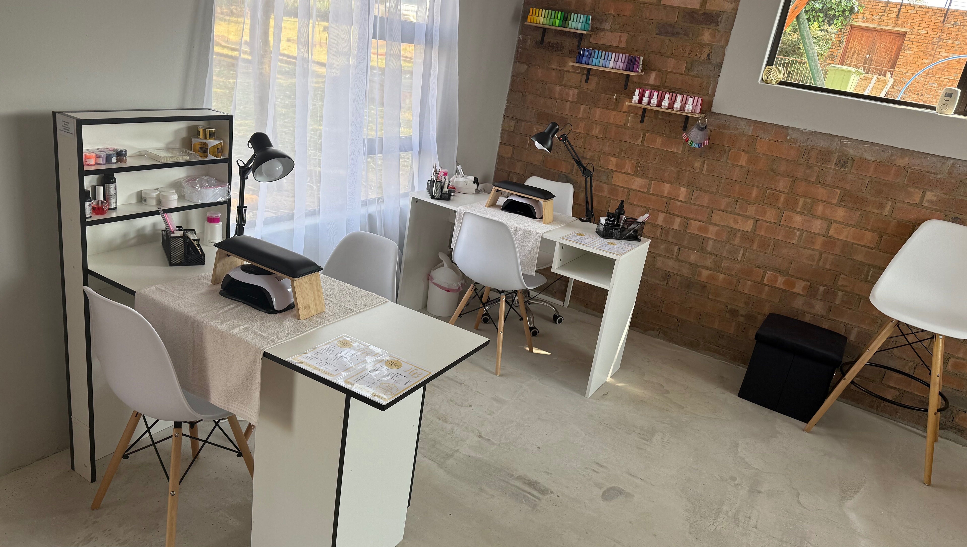 Elegant nail stations at Honey Blush Beauty, Middelburg, Mpumalanga, ZA, showcasing tools and cozy seating.