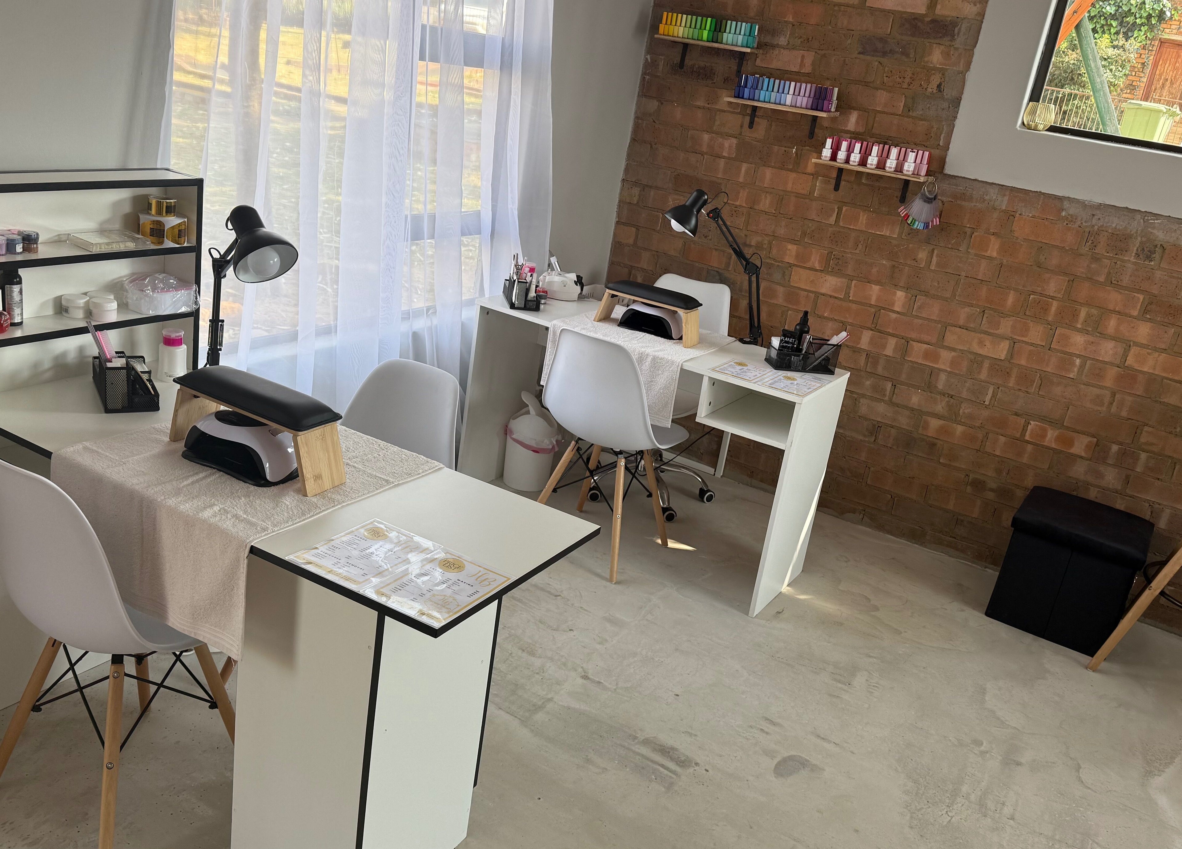 Elegant nail stations at Honey Blush Beauty, Middelburg, Mpumalanga, ZA, showcasing tools and cozy seating.