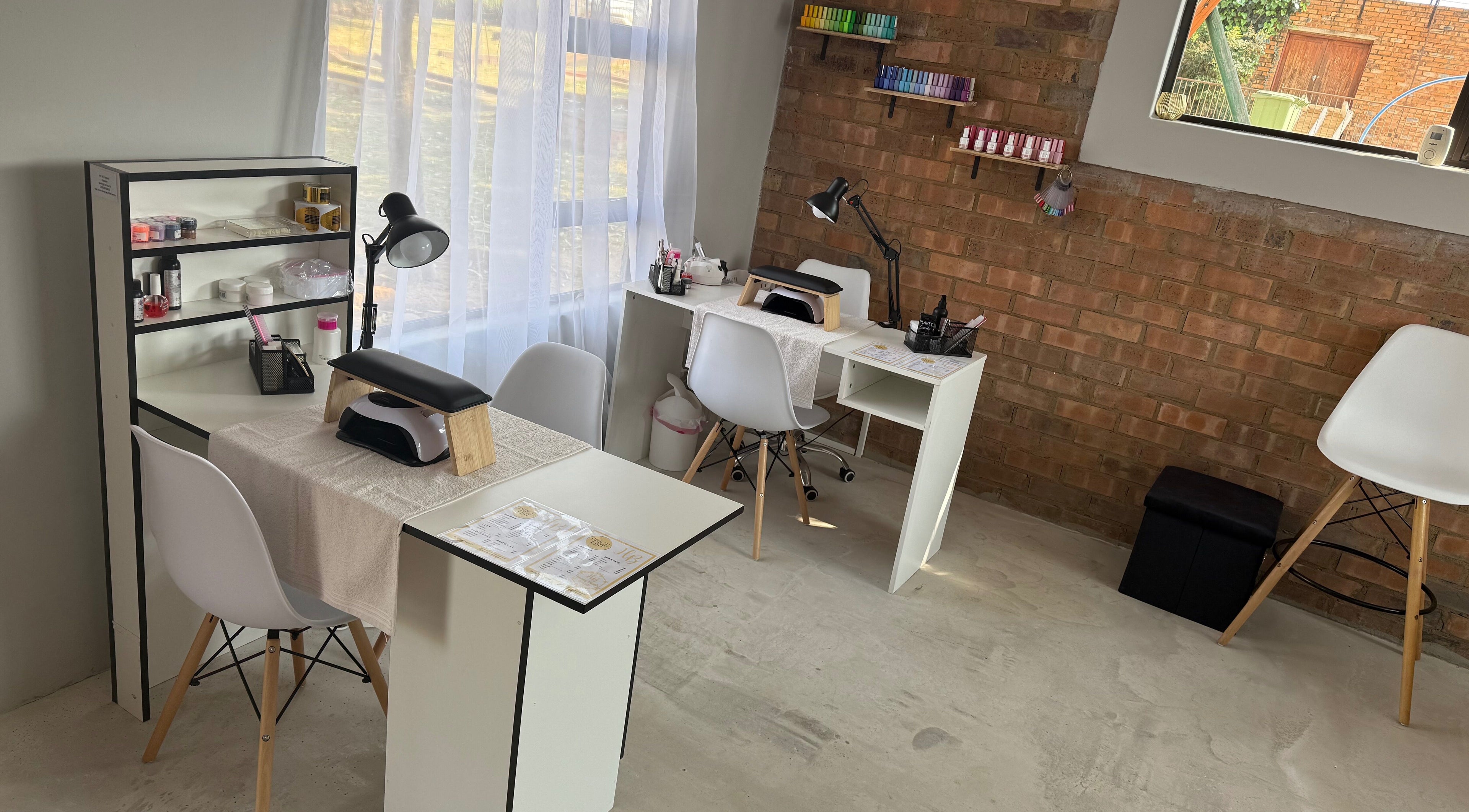 Elegant nail stations at Honey Blush Beauty, Middelburg, Mpumalanga, ZA, showcasing tools and cozy seating.
