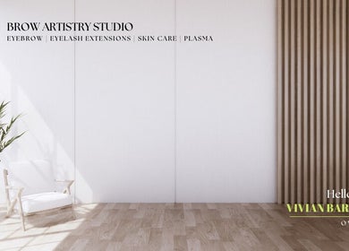 Bright, minimalist studio at Brow Artistry Studio, Anaheim, California, US with a white chair and green plant.