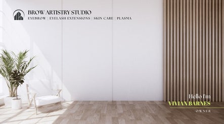 Bright, minimalist studio at Brow Artistry Studio, Anaheim, California, US with a white chair and green plant.