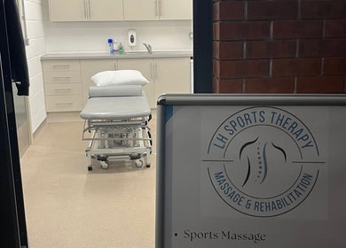 Interior view of LH Sport Therapy, Mumbles, Newton, Wales, GB, featuring a massage table and treatment area.