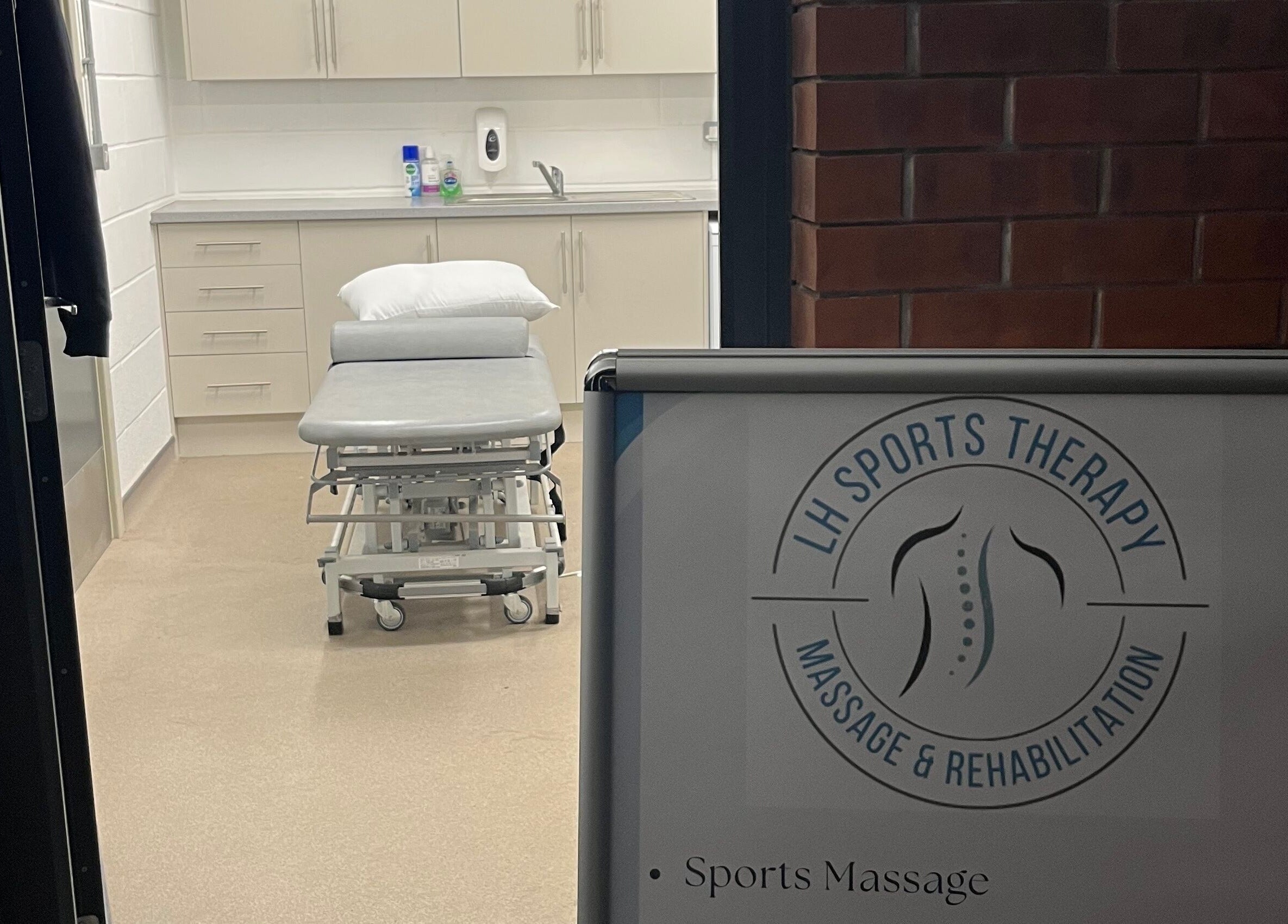 Interior view of LH Sport Therapy, Mumbles, Newton, Wales, GB, featuring a massage table and treatment area.