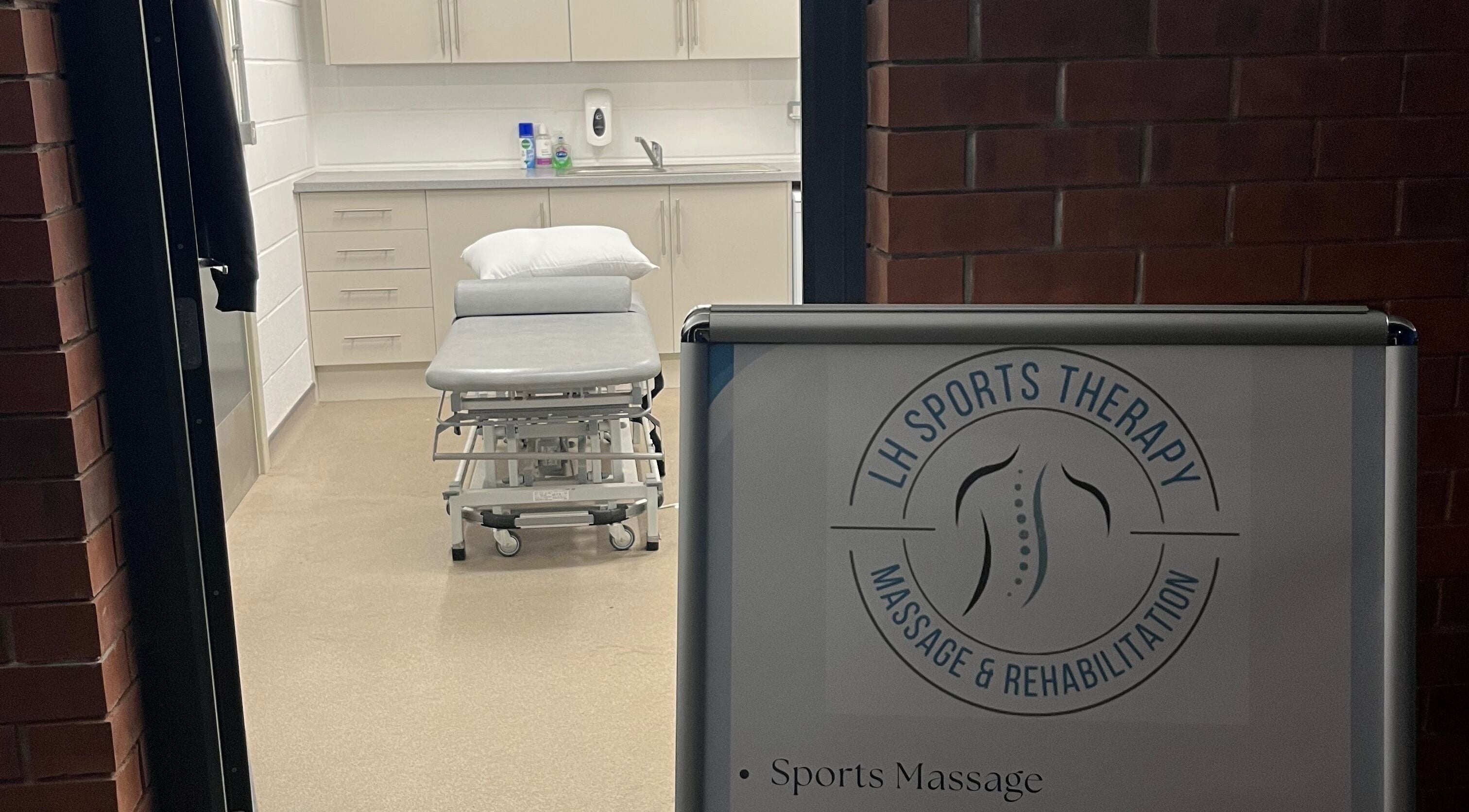 Interior view of LH Sport Therapy, Mumbles, Newton, Wales, GB, featuring a massage table and treatment area.