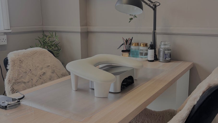 Cozy nail desk setup at Sculpted Studio in Cwmtillery, Wales, GB featuring a lamp and cozy chair.