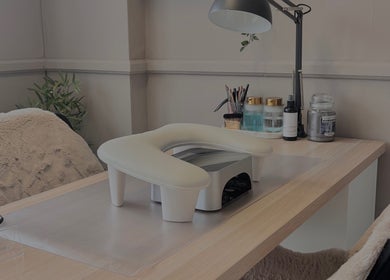 Cozy nail desk setup at Sculpted Studio in Cwmtillery, Wales, GB featuring a lamp and cozy chair.