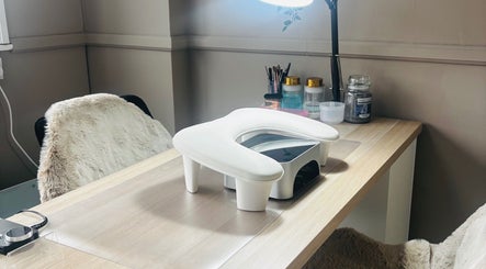 Elegant nail station at Sculpted Studio in Cwmtillery, Wales, GB, featuring a modern setup and soft seating.