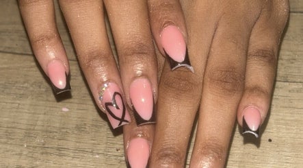 Stylish nail design at Flyynailss, Saint James, BB featuring pink polish with heart detail.
