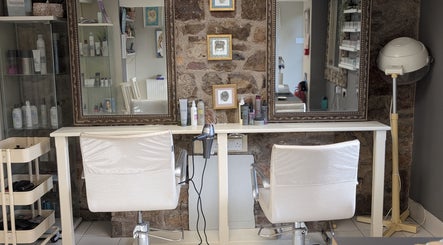 Elegant salon interior at LoXs in Tutshill, England, GB showcasing stylish chairs and mirrors.