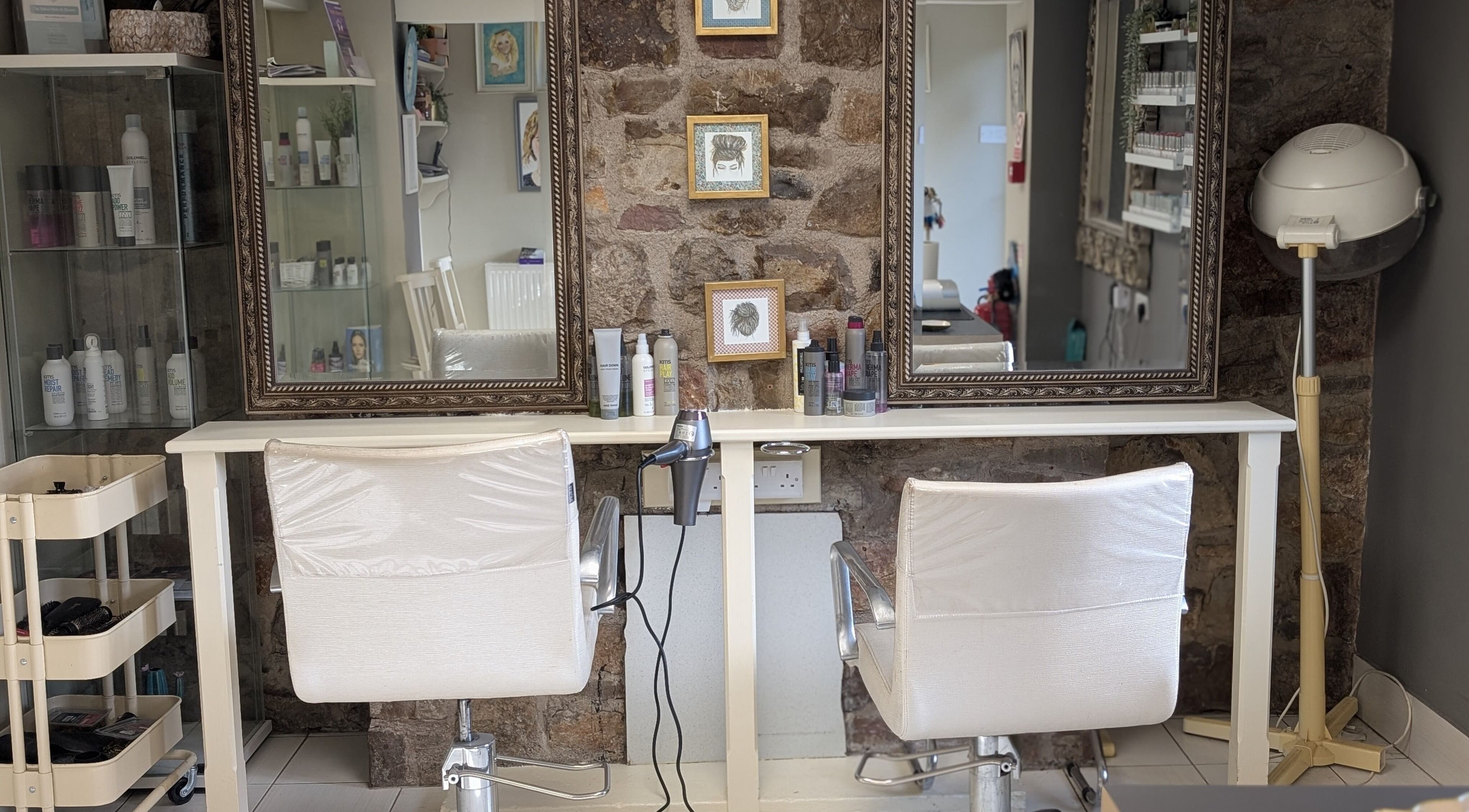 Chic salon setup at LoXs, Tutshill, England. Features matching chairs, styling tools, and elegant decor.
