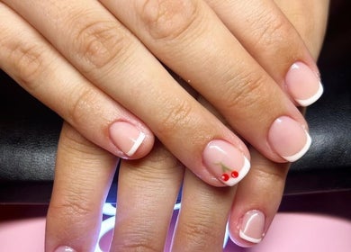 Elegant French manicure at Rose Dipped Nails, Southampton, England, GB with chic cherry nail art.