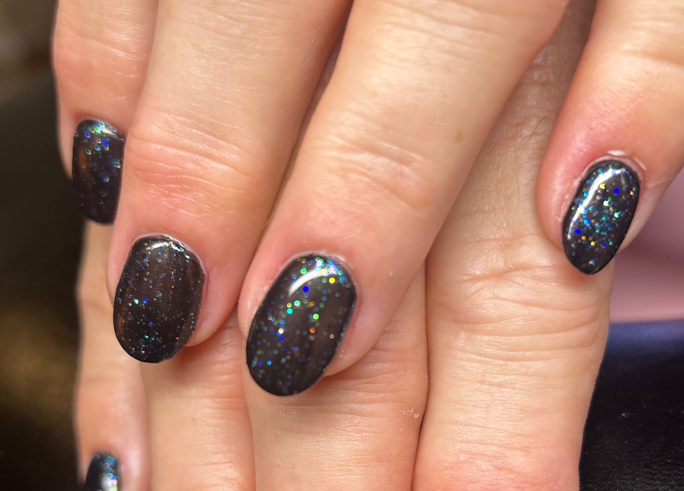 Sparkling black nails with glitter design at Rose Dipped Nails, Southampton, England, GB.