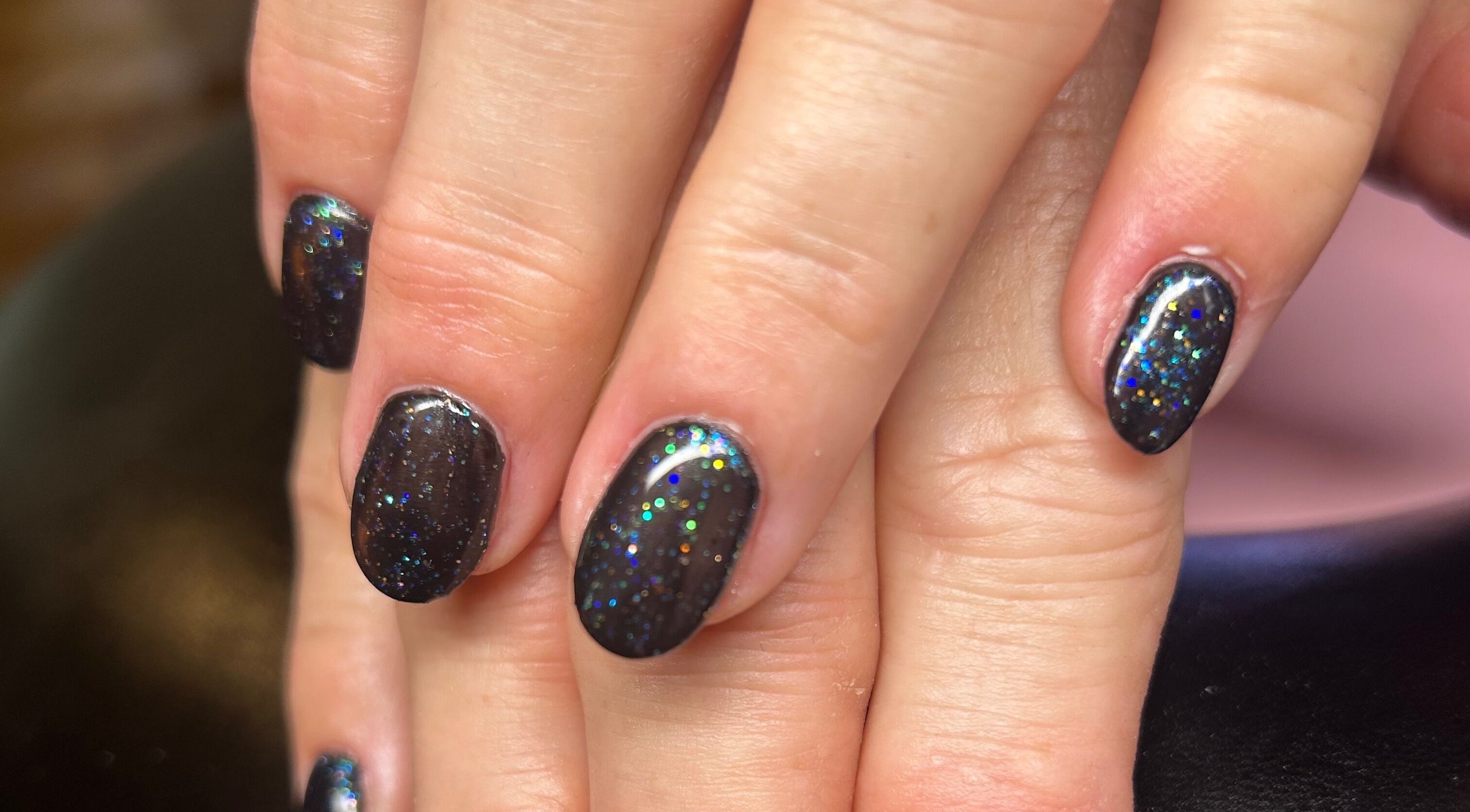 Sparkling black nails with glitter design at Rose Dipped Nails, Southampton, England, GB.