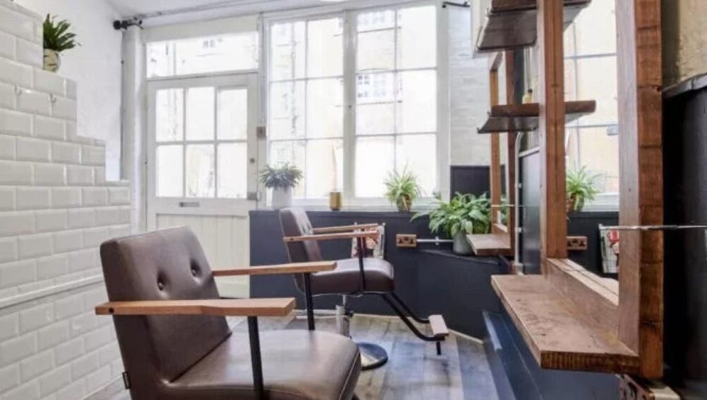 Elegant styling area at Hair by Cristian, London, England, GB with modern chairs and natural lighting.