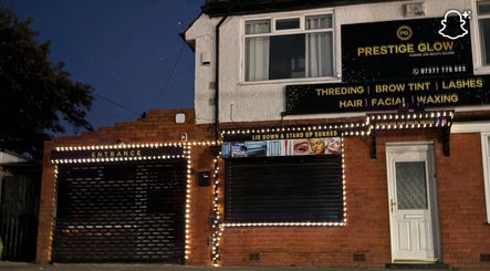 Prestige Glow's illuminated entrance in Bolton, England, GB, showcasing beauty and wellness services.