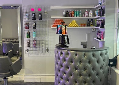 Reception area at Prestige Glow, Bolton, England, GB showcasing beauty products and plush furnishings.