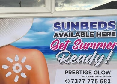 Sunbed advertisement at Prestige Glow, Bolton, England, GB. Get summer ready with premium tanning services.
