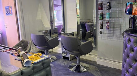 Modern salon interior at Prestige Glow, Bolton, England, GB with sleek chairs and mirrors.