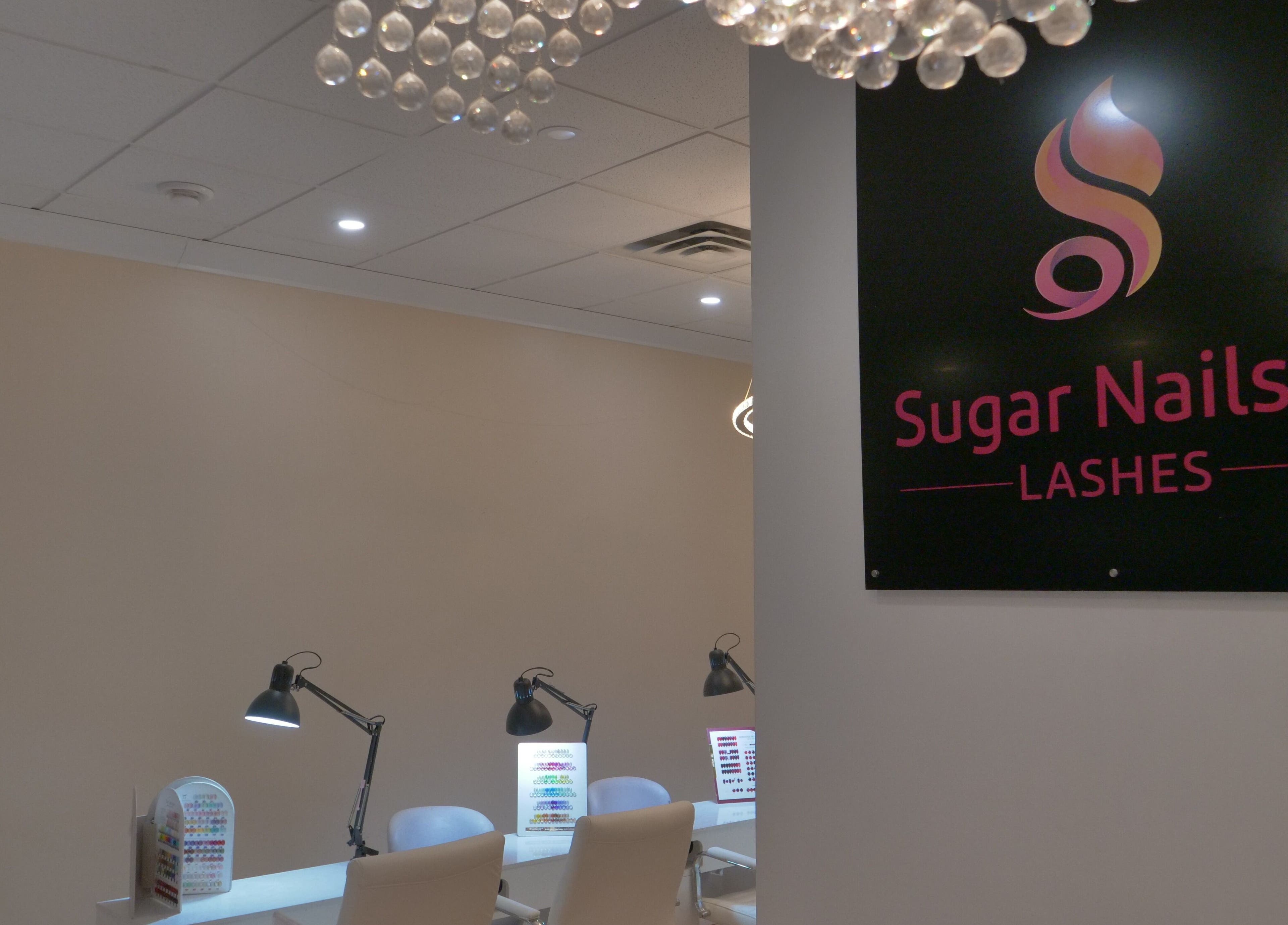 Modern interior of Sugar Nails and Lashes - Kitsilano, Vancouver, BC, CA, featuring sleek nail workstations.