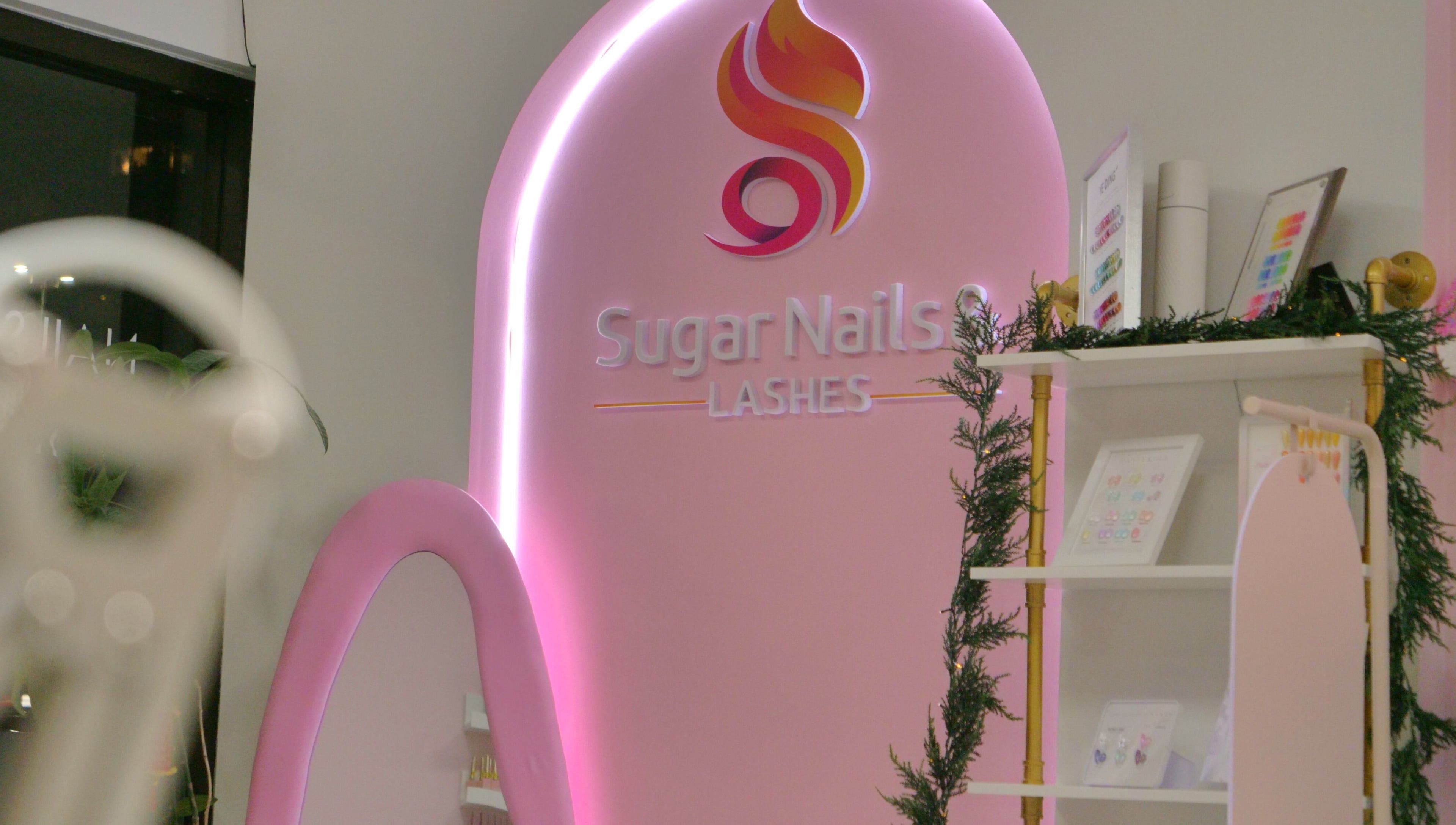 Sugar Nails and Lashes - Richmond interior adorned with pink neon sign, British Columbia, CA.