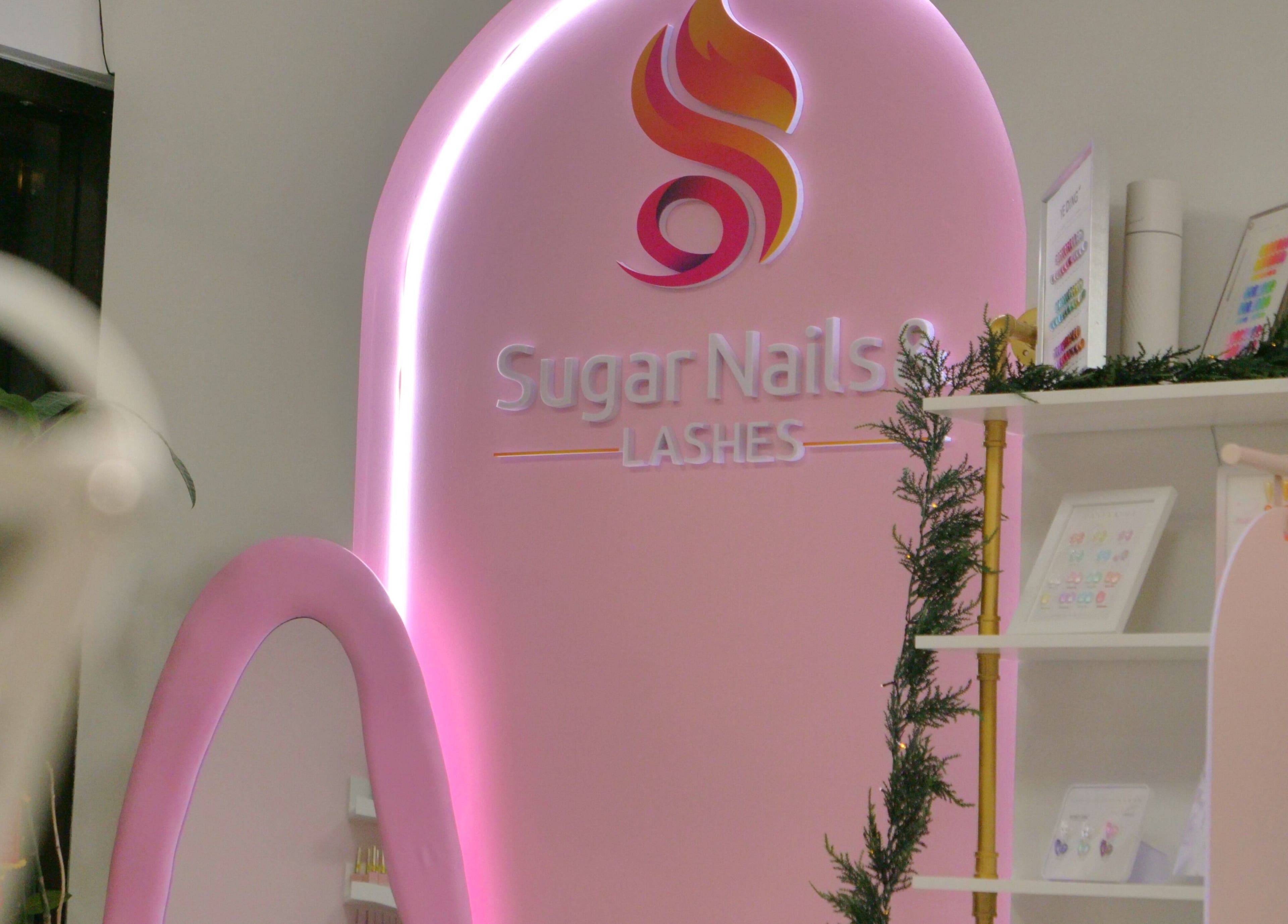 Sugar Nails and Lashes - Richmond interior adorned with pink neon sign, British Columbia, CA.