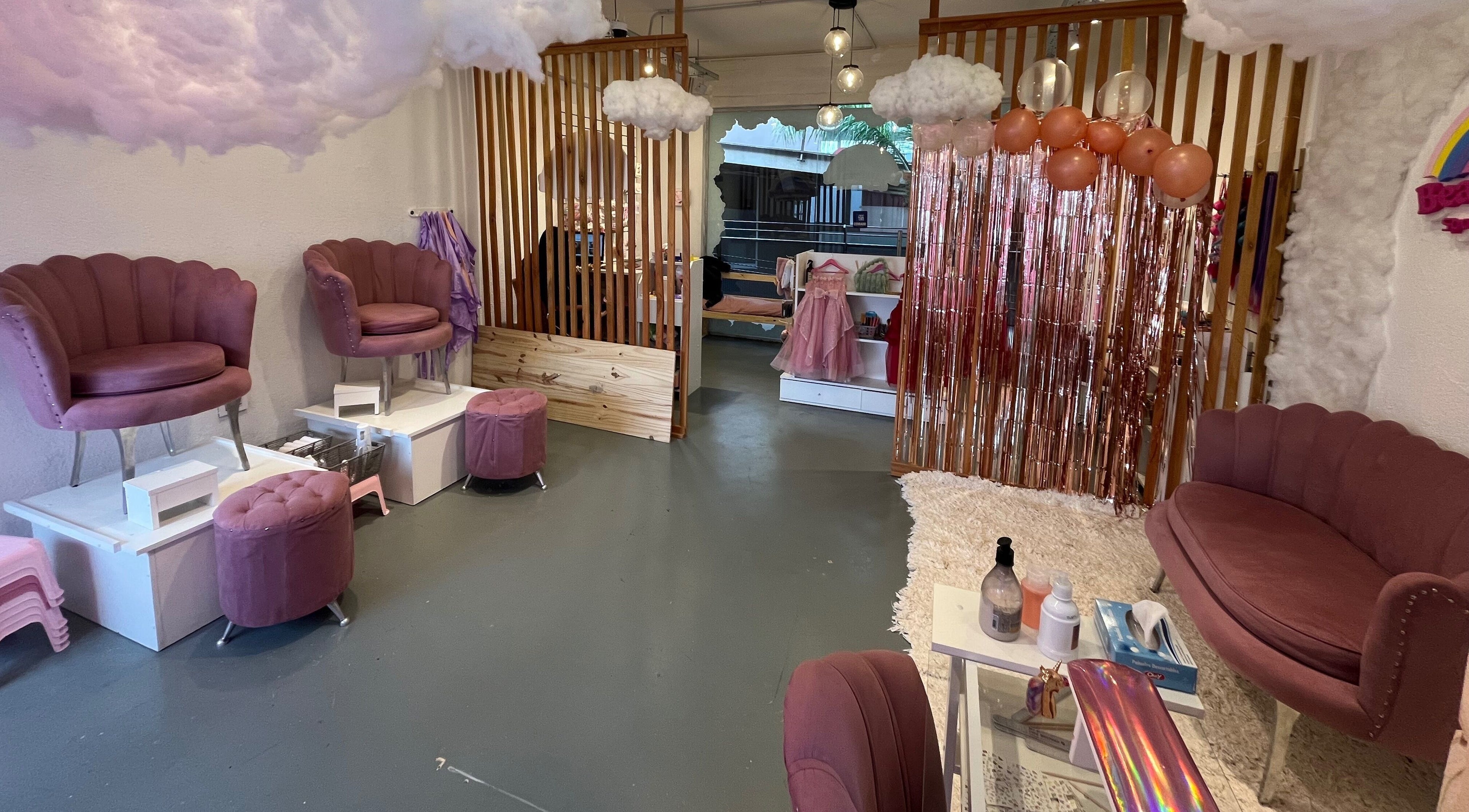 Interior del elegante Beautyland spa & Accesorios, Buenos Aires. Sillas rosas y decoración lujosa.