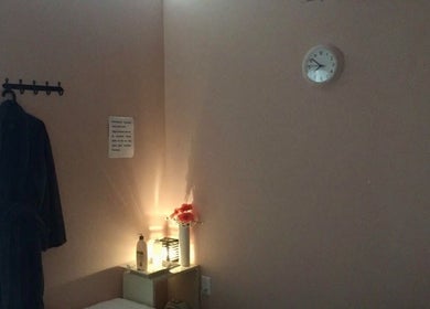 A tranquil treatment room at Symmetry Spa in Seattle, Washington, US with a robe, soft lighting, and decor.