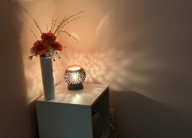 Serene vase and lit lamp at Symmetry Spa in Seattle, Washington, US creating a cozy ambiance.