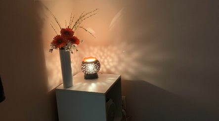 Serene vase and lit lamp at Symmetry Spa in Seattle, Washington, US creating a cozy ambiance.