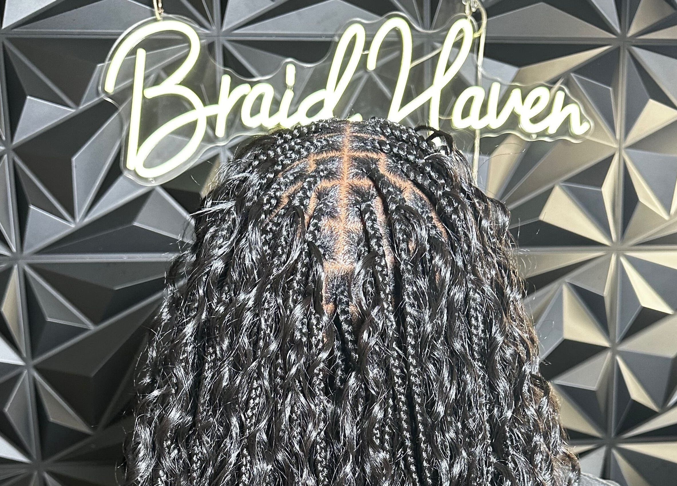 Stylish braids at Braid Haven, Nassau, New Providence, BS, against a chic geometric wall.
