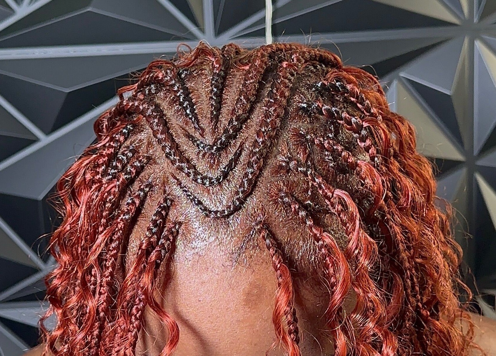 Intricate red braids at Braid Haven, Nassau, New Providence, BS.