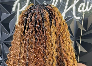 Stylish braided hairstyle at Braid Haven, Nassau, New Providence, BS, showcasing intricate cornrows and curls.
