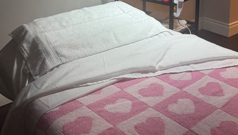 Cozy treatment bed with heart-patterned blanket at The Radiantix Spa in Toronto, Ontario, CA.