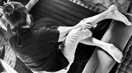 Therapist giving a relaxing massage at Muka Concepts X Bambu Indah in Bali, Bali, ID.