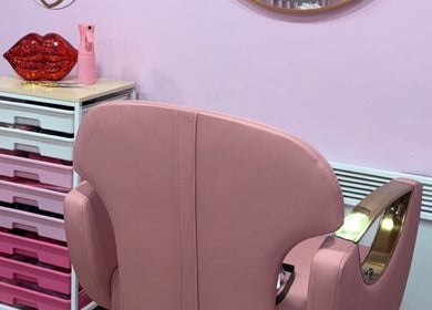 Elegant pink salon chair at Dollys Studio, Bradford, England, GB in a stylish, modern setting.